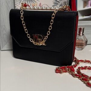 Chic Black and Red Crossbody Bag with Gold Chain
